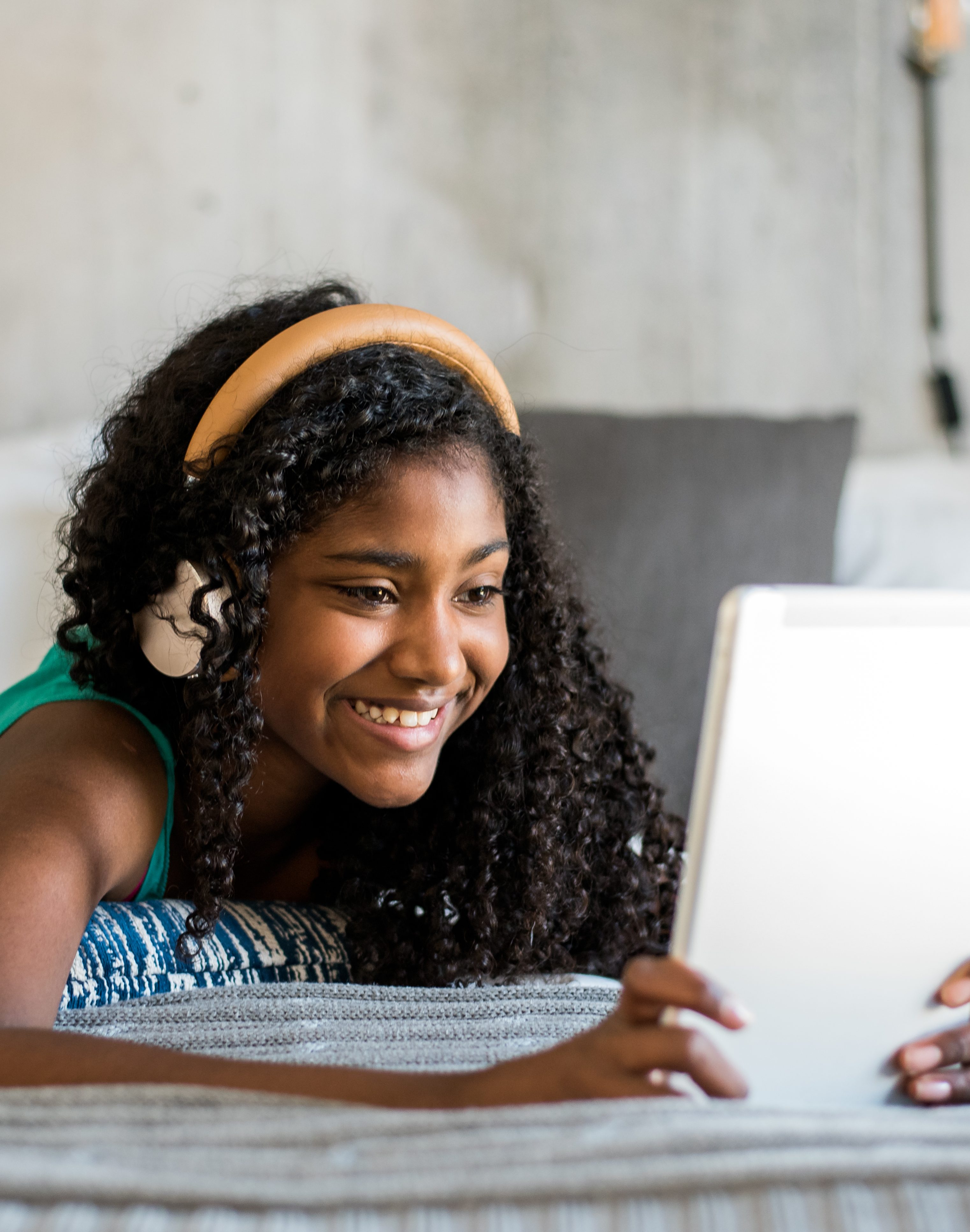 Black teenage reading a book on bed