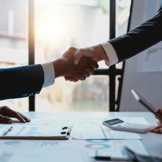 Business people shaking hands to congratulate success.