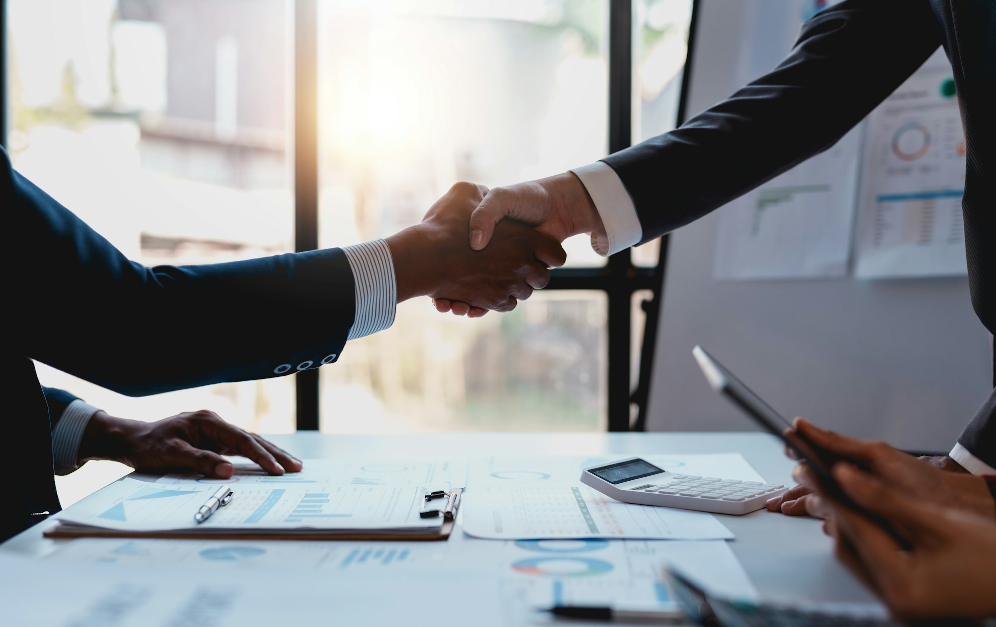 Business people shaking hands to congratulate success.